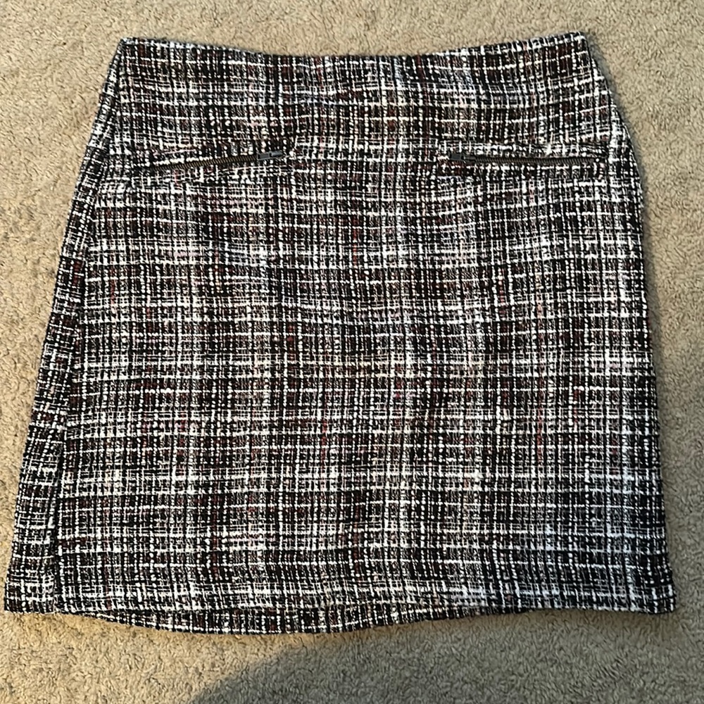Black, pink and white patterned skirt.